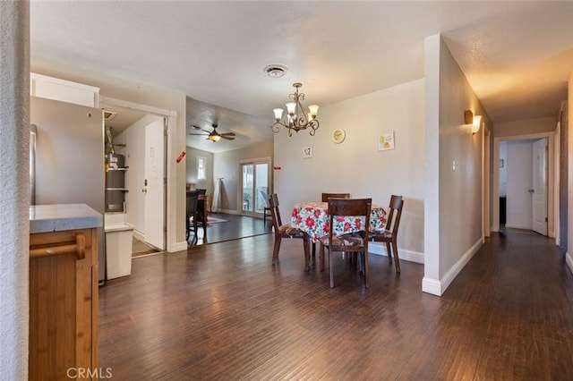 dining room featuring baseboards, visible vents, dark wood-style floors, and ceiling fan with notable chandelier