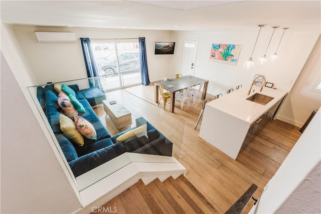 312 36th St, Newport Beach, CA 92663 - living area with an AC wall unit and light wood-style flooring