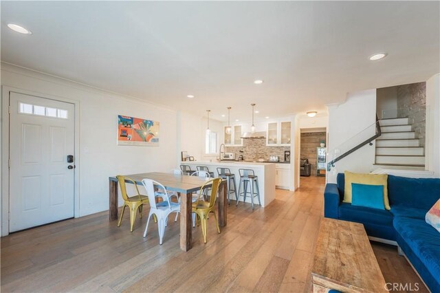 312 36th St, Newport Beach, CA 92663 - dining area featuring recessed lighting, light wood finished floors, stairs, and ornamental molding