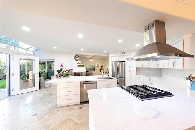 22421 Birchcrest, Mission Viejo, CA 92692 - kitchen with light stone counters, a sink, island exhaust hood, stainless steel appliances, and a peninsula