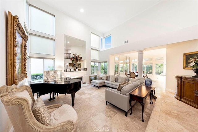 22421 Birchcrest, Mission Viejo, CA 92692 - living room with a towering ceiling, healthy amount of natural light, decorative columns, and baseboards