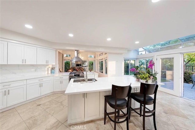 22421 Birchcrest, Mission Viejo, CA 92692 - kitchen featuring a sink, light countertops, white cabinetry, recessed lighting, and a kitchen breakfast bar