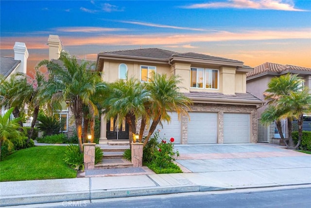 22421 Birchcrest, Mission Viejo, CA 92692 - view of front of home featuring a yard, stucco siding, an attached garage, driveway, and stone siding