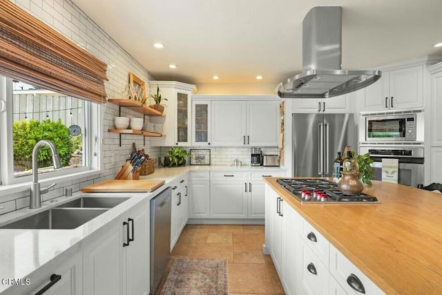 614 Crestview Dr, Ojai, CA 93023 - kitchen with stainless steel appliances, exhaust hood, a sink, tasteful backsplash, and light countertops