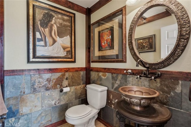33228 Romance Pl, Temecula, CA 92592 - half bathroom featuring tile walls, toilet, and wainscoting