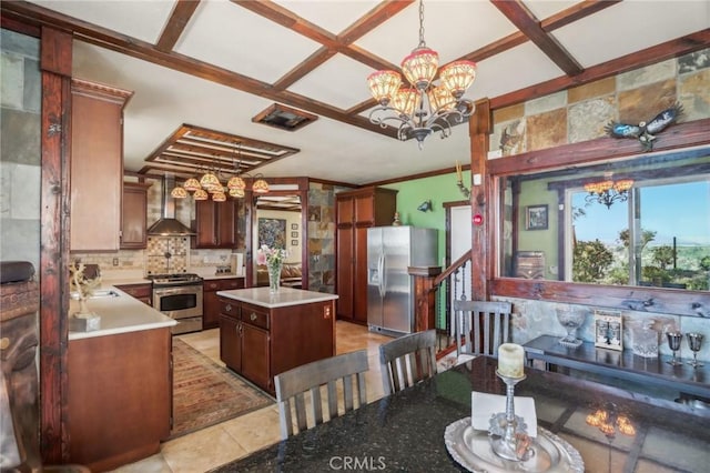 33228 Romance Pl, Temecula, CA 92592 - kitchen with an inviting chandelier, wall chimney exhaust hood, appliances with stainless steel finishes, and a kitchen island