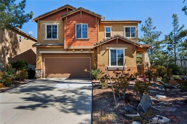 33228 Romance Pl, Temecula, CA 92592 - craftsman house featuring fence, driveway, stucco siding, and a garage