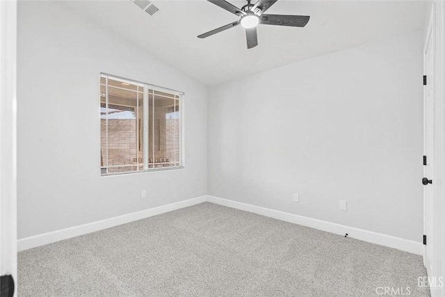 carpeted spare room with ceiling fan, vaulted ceiling, visible vents, and baseboards