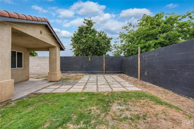 view of yard featuring a patio area and a fenced backyard