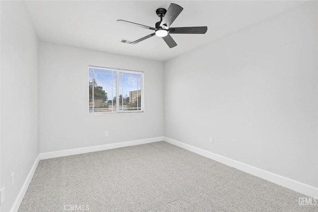 carpeted empty room featuring baseboards, a ceiling fan, and visible vents