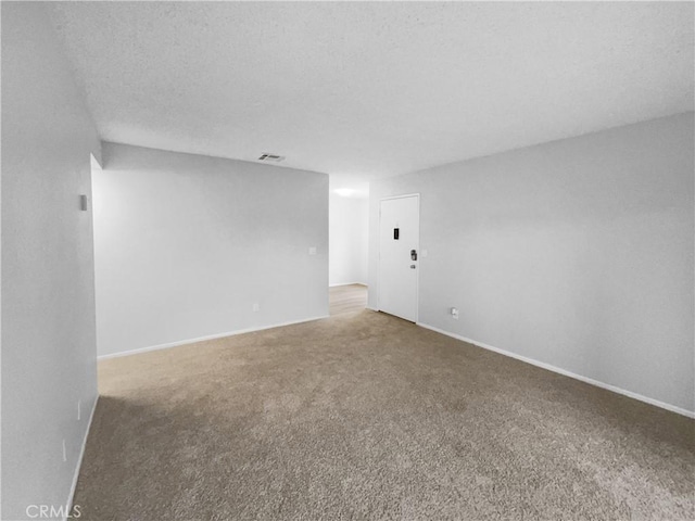 carpeted empty room with baseboards and visible vents