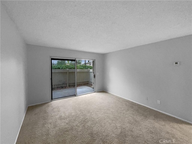 unfurnished room featuring carpet floors, baseboards, and a textured ceiling
