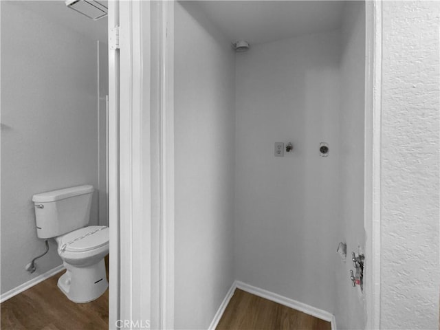 bathroom featuring toilet and wood finished floors
