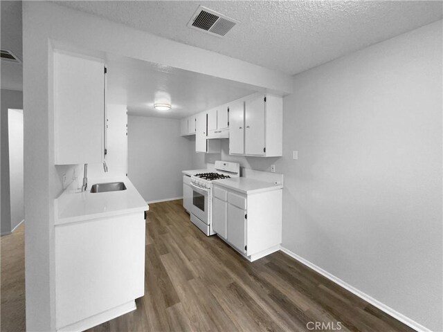 1800 E Old Ranch Rd, Colton, CA 92324 - kitchen featuring white range with gas stovetop, a sink, baseboards, dark wood-style flooring, and light countertops