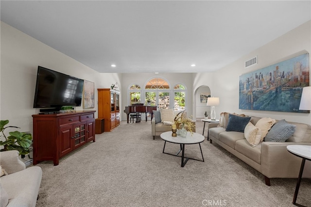 living area featuring light carpet, visible vents, and recessed lighting