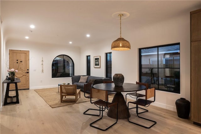 dining room with recessed lighting, light wood-style floors, and baseboards