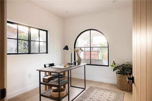 home office with baseboards and light wood-style floors
