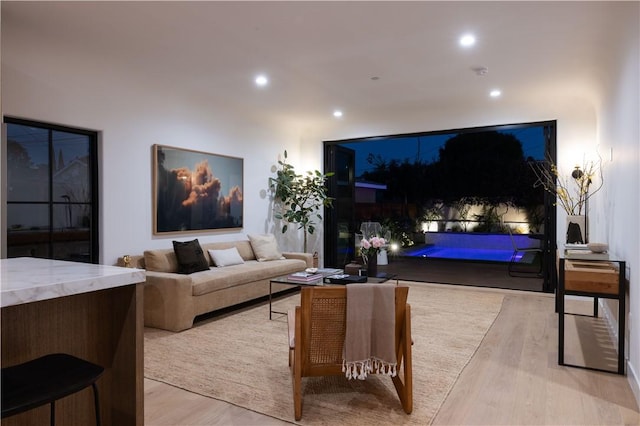 living area featuring recessed lighting and light wood-style flooring
