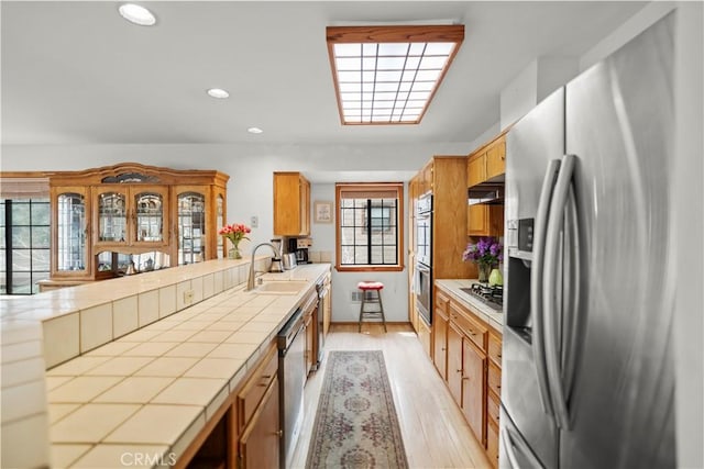 2116 Ironwood Ct, Pine Mountain Club, CA 93222 - kitchen with tile counters, a sink, light wood finished floors, appliances with stainless steel finishes, and recessed lighting