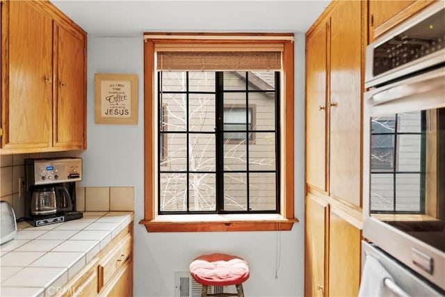 2116 Ironwood Ct, Pine Mountain Club, CA 93222 - kitchen featuring brown cabinets, stainless steel oven, and tile countertops
