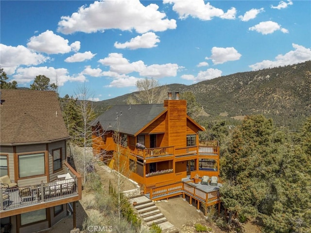 2116 Ironwood Ct, Pine Mountain Club, CA 93222 - rear view of house featuring a chimney, a balcony, and a mountain view
