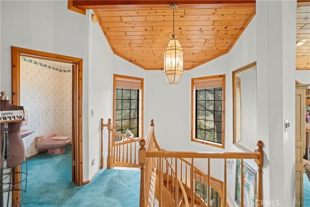 2116 Ironwood Ct, Pine Mountain Club, CA 93222 - hall with vaulted ceiling, an upstairs landing, carpet floors, wood ceiling, and a notable chandelier