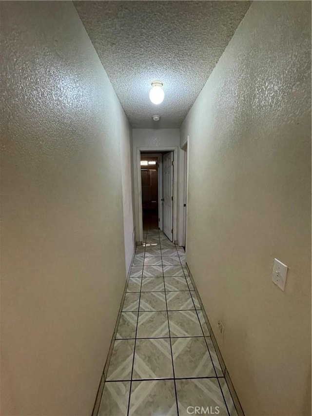 corridor with a textured ceiling