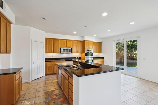 kitchen with stainless steel appliances, a sink, dark countertops, recessed lighting, and light tile patterned floors