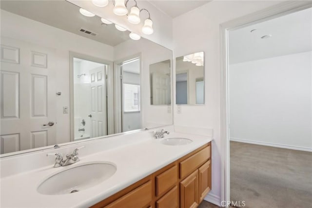 15688 Portenza Dr, Fontana, CA 92336 - bathroom featuring double vanity and baseboards
