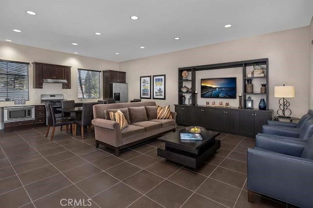 living room featuring dark tile patterned flooring and recessed lighting