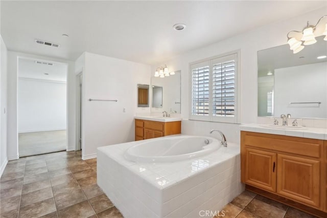 full bath with a bath, visible vents, a sink, and two vanities