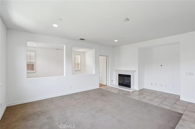 15688 Portenza Dr, Fontana, CA 92336 - unfurnished living room featuring baseboards, a glass covered fireplace, recessed lighting, tile patterned flooring, and carpet floors