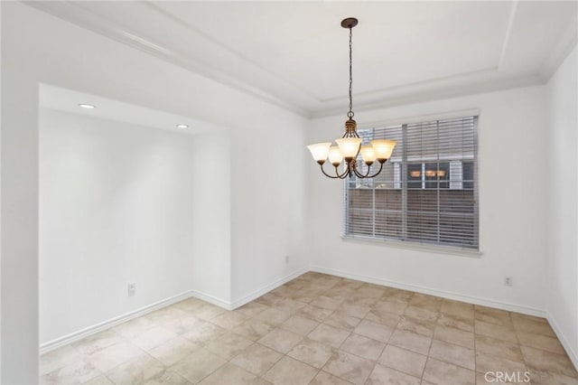 unfurnished room with an inviting chandelier, a raised ceiling, and baseboards