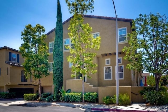 view of property exterior featuring a tile roof and stucco siding