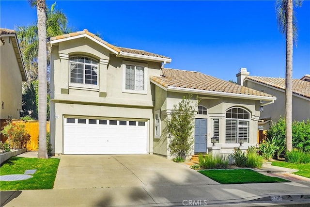 view of front of house featuring fence, stucco siding, an attached garage, a tile roof, and driveway