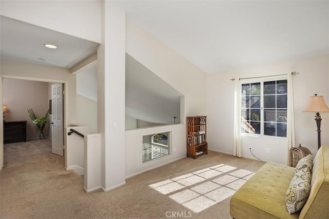 living room featuring carpet floors, vaulted ceiling, and baseboards