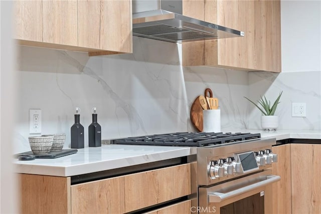kitchen featuring wall chimney exhaust hood, modern cabinets, light brown cabinets, and high end stove