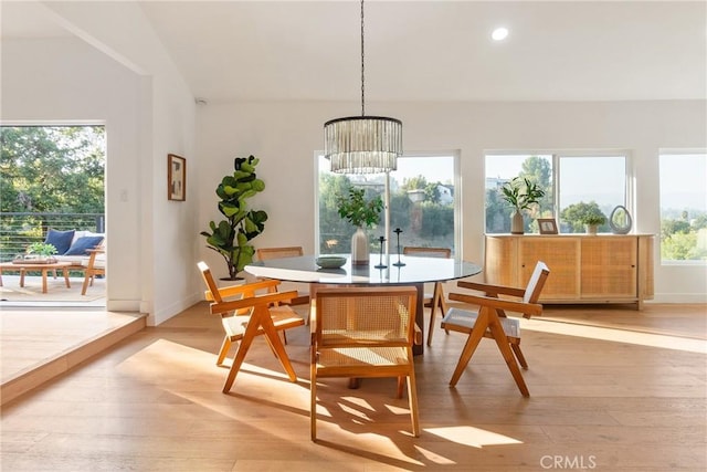 dining room with light wood-type flooring, vaulted ceiling, baseboards, recessed lighting, and a chandelier