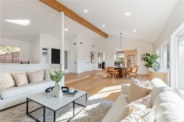 living area featuring recessed lighting, light wood finished floors, beamed ceiling, baseboards, and high vaulted ceiling