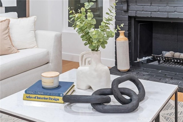 interior details with wood finished floors and a fireplace