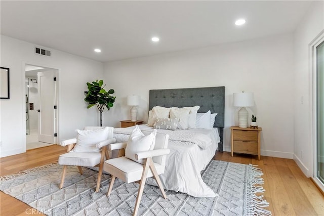 bedroom featuring light wood finished floors, visible vents, and recessed lighting