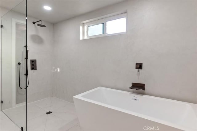 full bath with a freestanding bath, walk in shower, and tile patterned floors