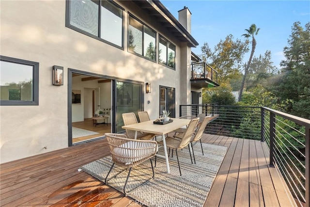 wooden terrace featuring outdoor dining space