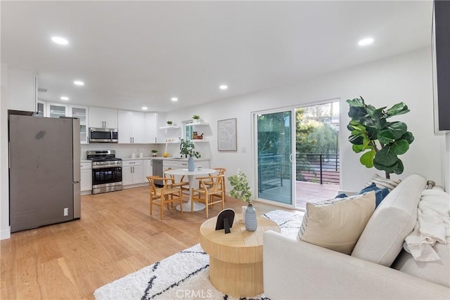 living area featuring light wood-style floors and recessed lighting