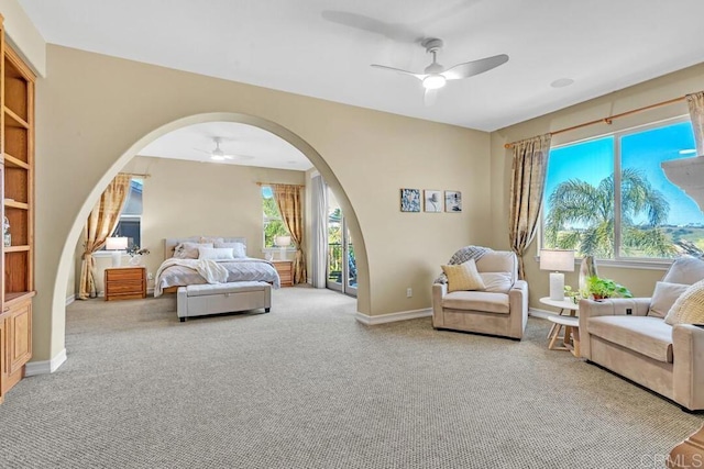 10495 Abalone Lndg, San Diego, CA 92130 - carpeted bedroom with arched walkways, a ceiling fan, access to outside, and baseboards