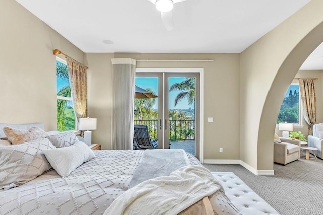 10495 Abalone Lndg, San Diego, CA 92130 - carpeted bedroom with arched walkways, access to outside, multiple windows, and baseboards