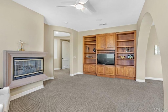 10495 Abalone Lndg, San Diego, CA 92130 - living area with arched walkways, carpet, a ceiling fan, and baseboards
