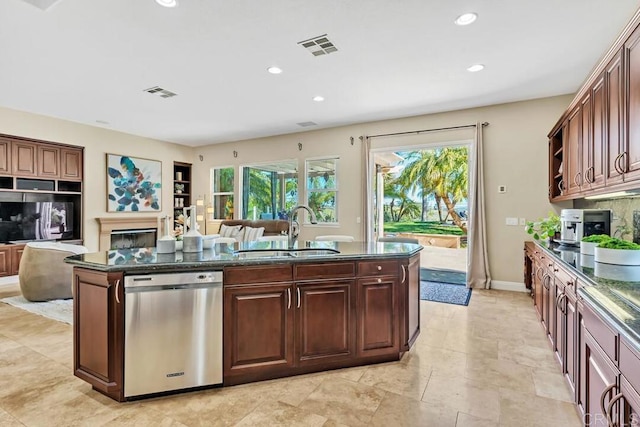 10495 Abalone Lndg, San Diego, CA 92130 - kitchen featuring stainless steel dishwasher, a sink, a center island with sink, a glass covered fireplace, and open floor plan