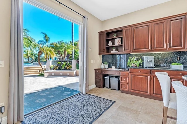 10495 Abalone Lndg, San Diego, CA 92130 - kitchen featuring backsplash, open shelves, and dark countertops