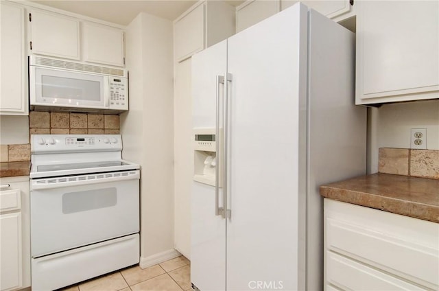 8566 Van Ness Ct Unit 21D, Huntington Beach, CA 92646 - kitchen featuring white appliances, light tile patterned floors, and white cabinetry